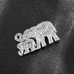 Detail view of the silver elephant brooch back with pin structure and textured finish