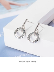 Detail of silver double hoop earrings with pavé cubic zirconia on minimalist display
