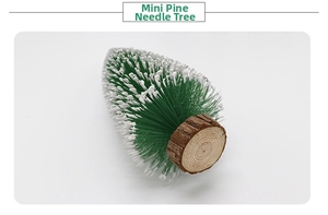 Detail of mini pine needle tree with snow effect on realistic wood base ornament