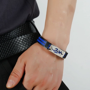 Detail of men's silicone bracelet with blue flame pattern on a silver metal plaque
