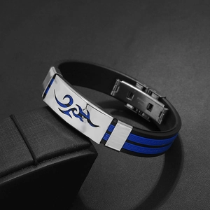 Detail of blue flame cut-out on stainless steel plate with black silicone band