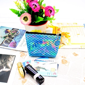 Close-up of iridescent fish scale pattern coin purse with silver zipper and metallic ring