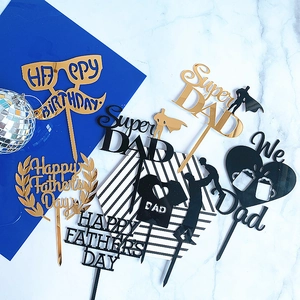 Flat lay of mirrored gold and black acrylic cake toppers for Father's Day and birthday parties