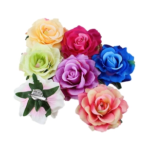 Detail view of multi-color fabric rose hair clips showing the versatile dual-clip backing