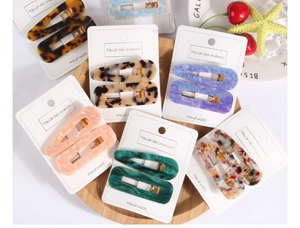 Detail of tortoise shell and marble acetate hair clips set on display cards