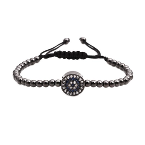 Macro shot of evil eye bracelet with gunmetal beads and blue zircon inlay details