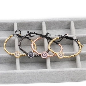 Detail of four woven Evil Eye bead bracelets with micro-set blue and white cubic zirconia