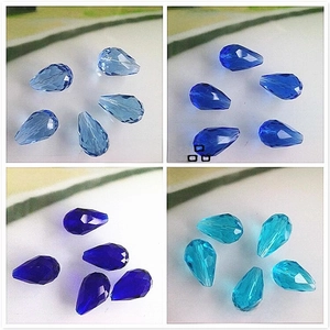 Detailed view of faceted teardrop glass beads in four shades of blue for DIY jewelry