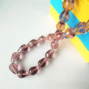 Macro shot of faceted light purple crystal teardrop beads for jewelry making DIY