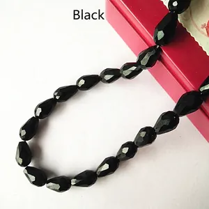 Macro detail of faceted black glass teardrop beads for DIY jewelry and accessories