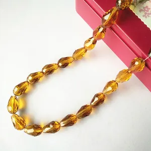 Macro shot of faceted tiger amber teardrop crystal beads for DIY jewelry making