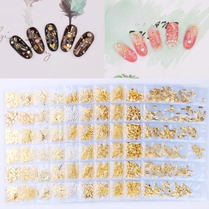 Golden and silver metal nail art studs set with celestial moon and star shapes in organizer box