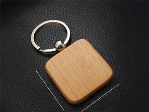 Close-up of a square beech wood keychain with rounded edges measuring 39mm by 39mm