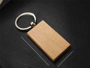 Detail shot of rectangular beech wood keychain with 55mm by 31mm size measurements