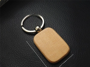 Macro shot of rectangular beech wood keychain with detailed natural wood grain texture