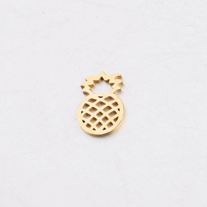 Macro shot of gold stainless steel hollow pineapple pendant with polished finish