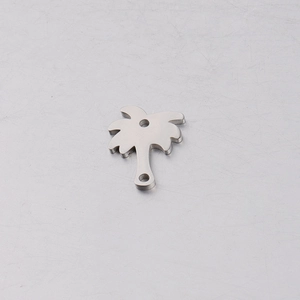 Close-up of silver coconut tree mirror stainless steel pendant on a grey surface