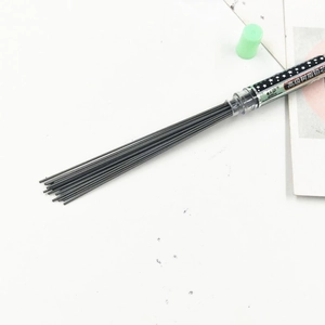 Macro shot of 2B resin pencil lead refills in a clear tube with a soft green cap