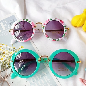 Detail of round floral and mint green children's sunglasses with UV400 CE protection