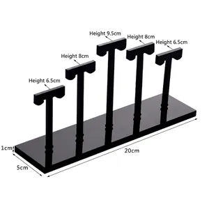 Black acrylic earring display set with five T-shaped holders in tiered heights and base
