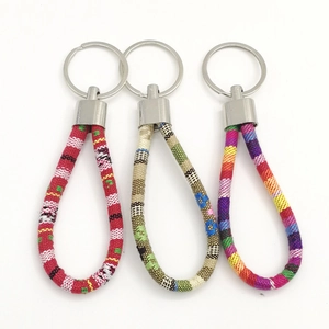 Close-up of colorful braided leather keychains with polished silver metal rings