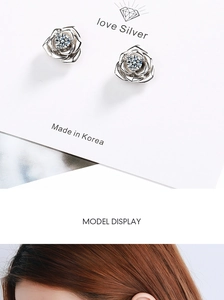 Macro detail of silver rose stud earrings with cubic zirconia and model display shot