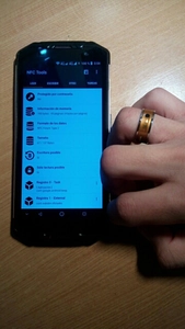Smartphone showing NFC Tools app interface scanning a black and gold smart ring