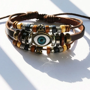 Close-up of vintage multilayer leather bracelet with blue eye charm and wooden beads