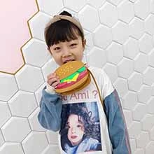 Close-up of a novelty hamburger shaped crossbody bag for kids with adjustable strap