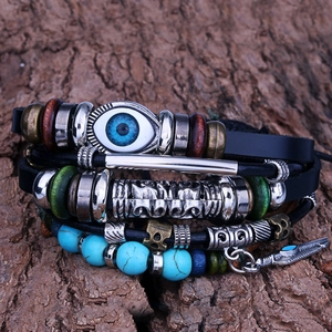 Multilayer leather bracelet with blue evil eye, turquoise beads, and feather charm