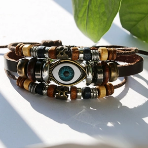 Detail of layered leather bracelet with turquoise evil eye bead and wooden accents