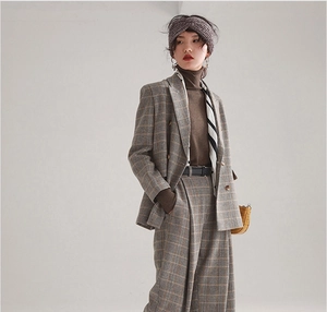 Detail of a grey knitted headband styled with a vintage plaid suit and silk scarf