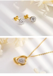 Detail of gold titanium heart necklace and crystal pave ball earrings with white flowers