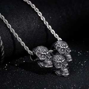 Retro stainless steel necklace featuring triple skull pendants on a thick rope chain