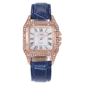 Detailed macro view of square rose gold watch case with crystal bezel and blue leather strap