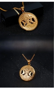 Detail of golden stainless steel Tree of Life pendant with pentagram and moon symbols