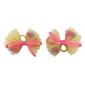 Detail of yellow mesh bow pet hair clips with pink ribbons and colorful inner beads