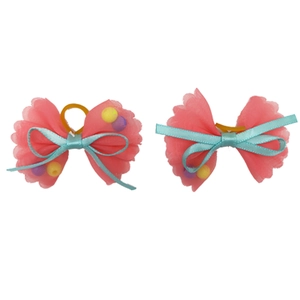 Close-up of pink and blue Valentine pet bows with mesh fabric and decorative beads