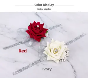 Close-up of red and ivory bridal wrist corsages with crystal chains and rose details