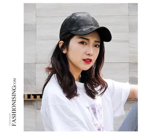 Detail of black camouflage baseball cap with textured fabric and curved brim on model