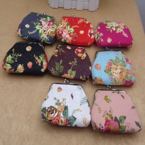 Top view of eight vintage floral canvas coin purses with metal clasp in various colors
