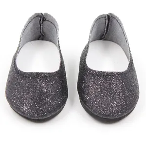 Detailed view of black sequin doll shoes with glitter finish and white inner soles
