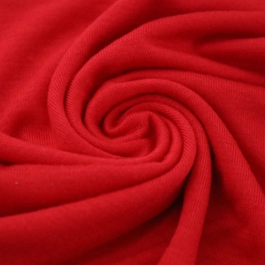 Red mercerized cotton tube hat fabric showing soft texture and spiral folds