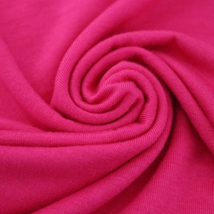 Detailed macro view of bright pink mercerized cotton fabric with soft knitted texture