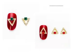 Macro detail of 3D triangle nail charms with square crystal inlay and mini rhinestones
