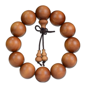 Authentic Indonesian Sandalwood prayer beads with dark brown knots on white background
