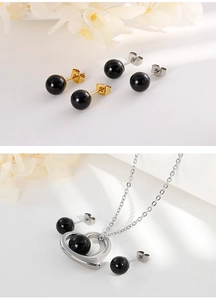 Detailed set of silver heart necklace with black beads and matching stud earrings