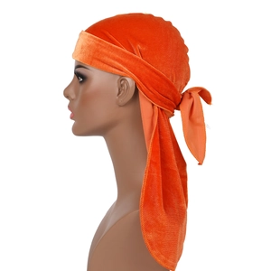 Orange velvet durag with extra long straps shown from side view on mannequin head