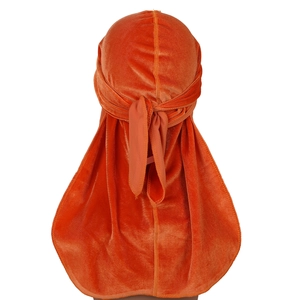 Orange velvet durag with long tail for hair waves shown from a rear view perspective