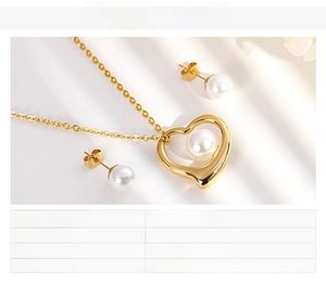 Detail view of heart pendant shell pearl necklace and stud earrings on white silk fabric